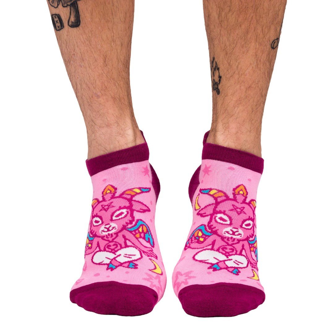 Ultimate Baphomet ankle socks in pink with magenta cuffs, cartoon pattern detail.