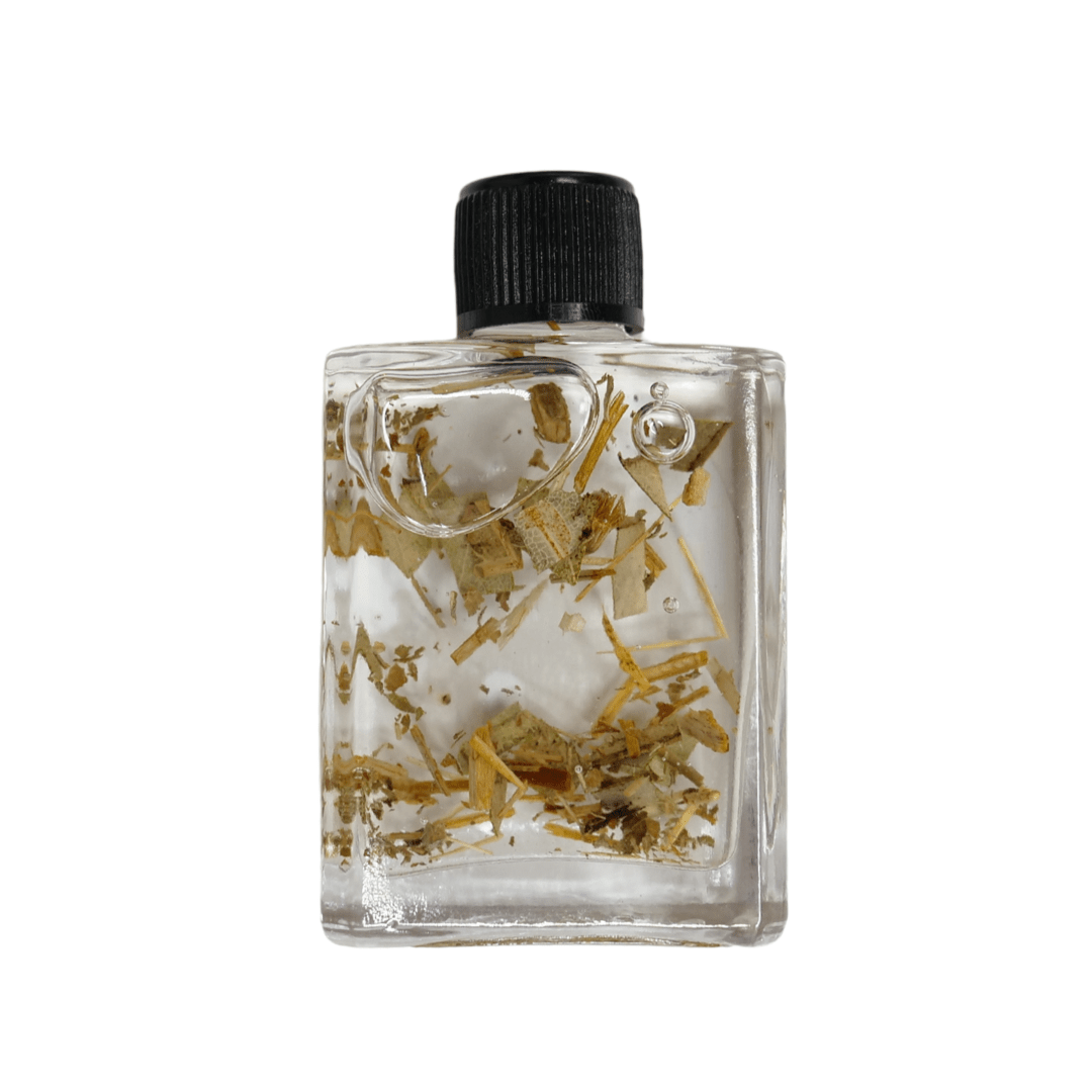 Clear bottle with black cap containing small stones and gold leaf on a white background