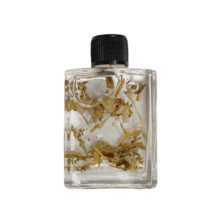 Clear bottle with black cap containing small stones and gold leaf on a white background