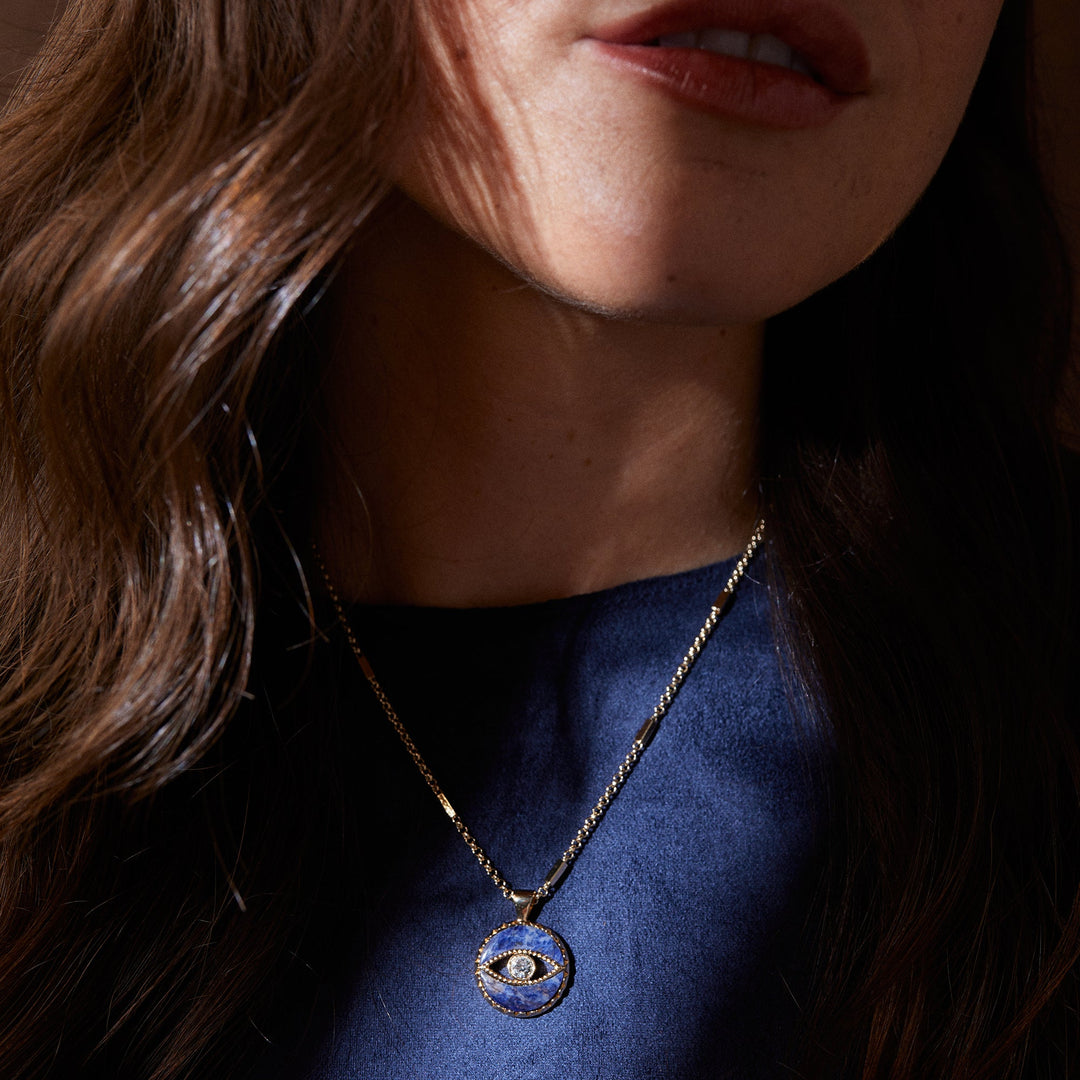 Woman wearing a necklace with an eye-shaped pendant
