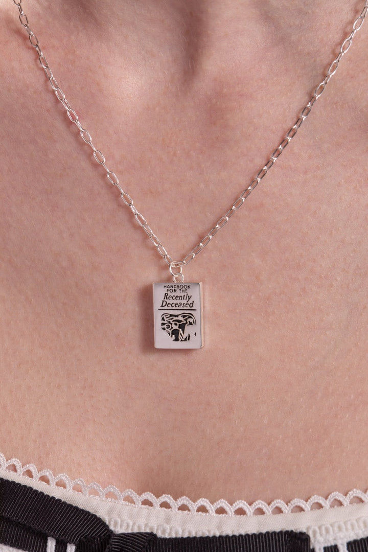 Necklace with a pendant on a person's neck