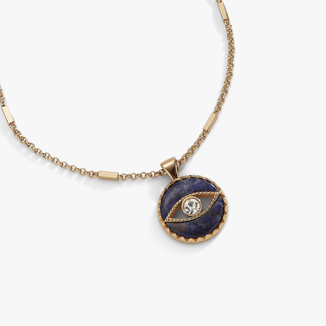 Gold necklace with a blue stone pendant on a white background