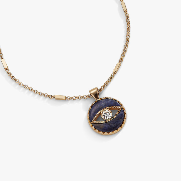 Gold necklace with a blue stone pendant on a white background