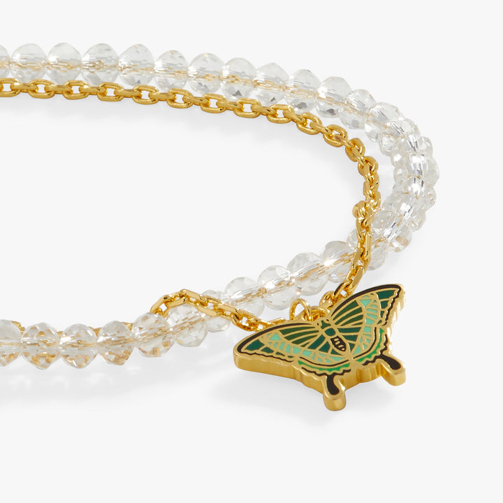 Necklace with gold chain and green butterfly pendant on a white background