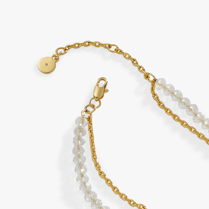 Gold chain necklace with a clasp on a white background