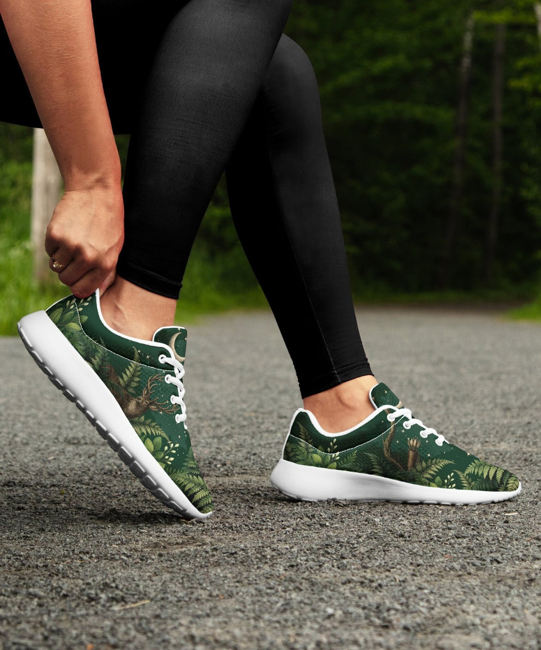 Artemis Sneakers in green forest print with white laces on gray pavement.