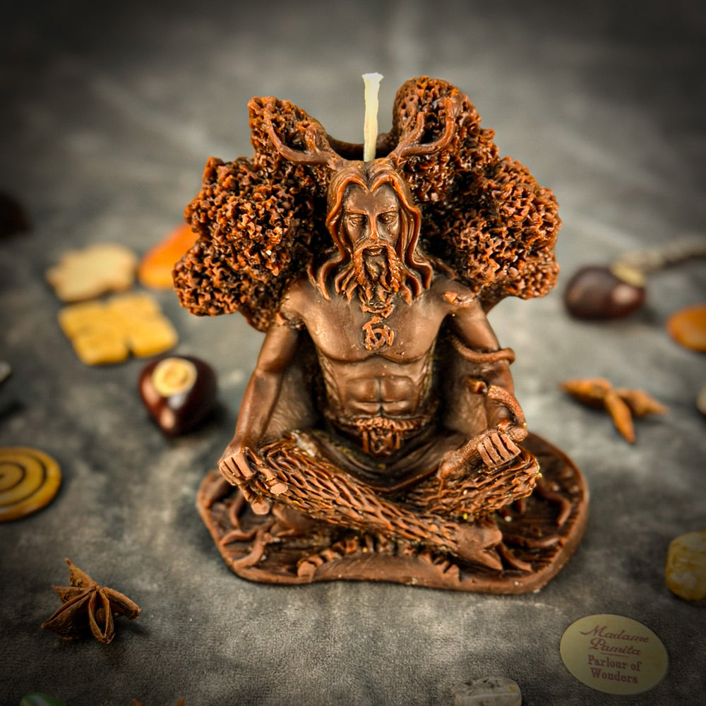 Beeswax Horned God Spell Candle close-up with lit wick and textured brown figure.