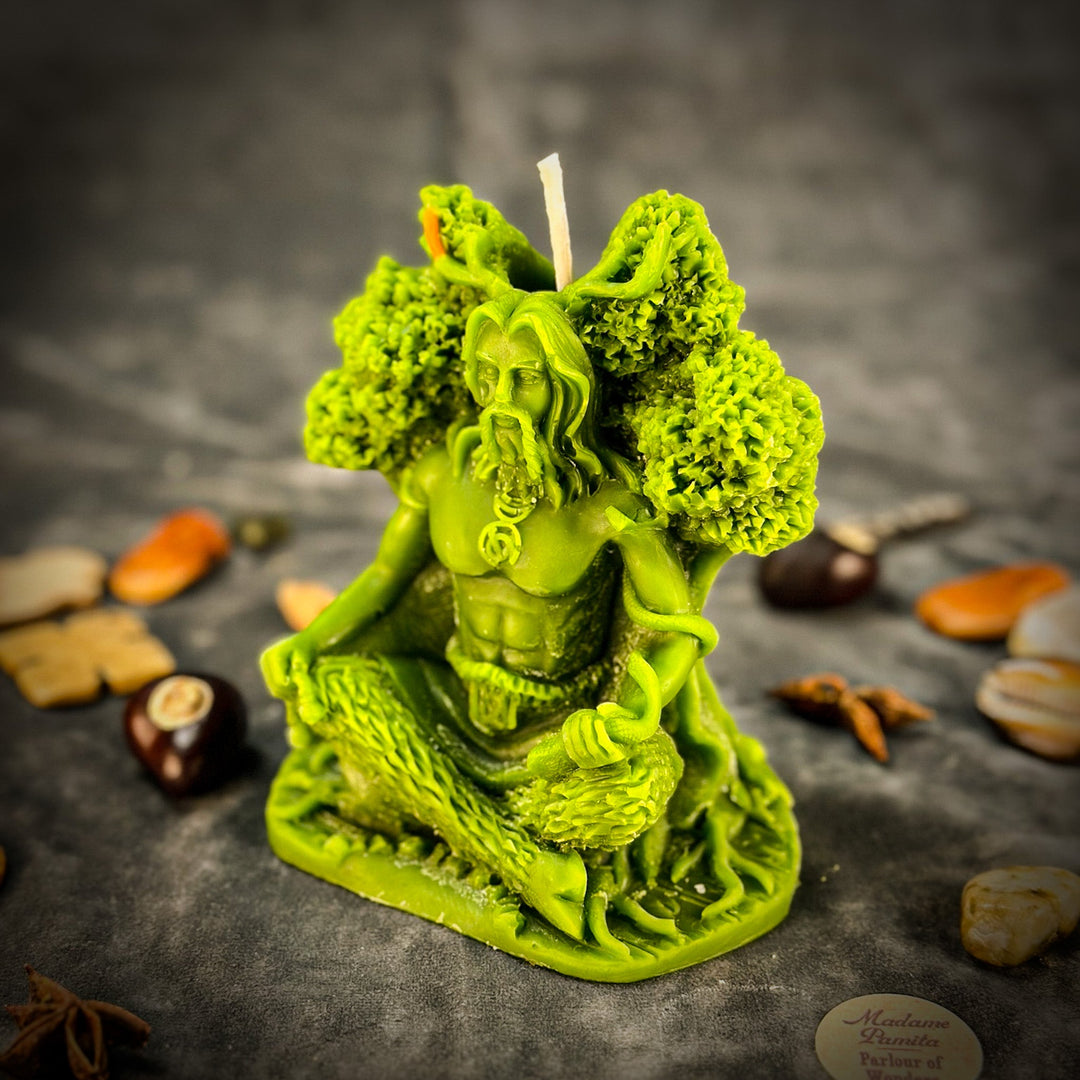 Beeswax Horned God Spell Candle detail, glowing green figure with lit wick.