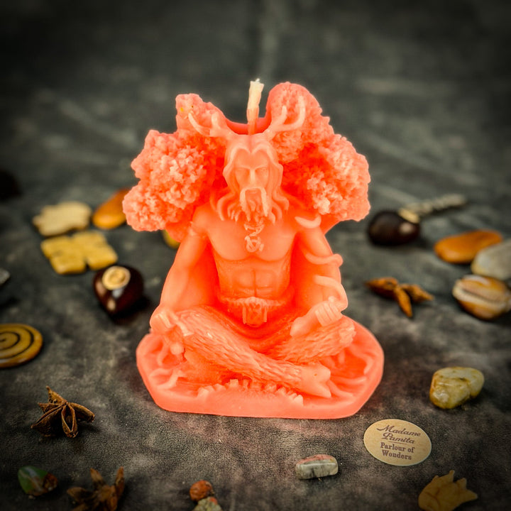 Beeswax Horned God Spell Candle with glowing orange-red figure and raised flame wick.