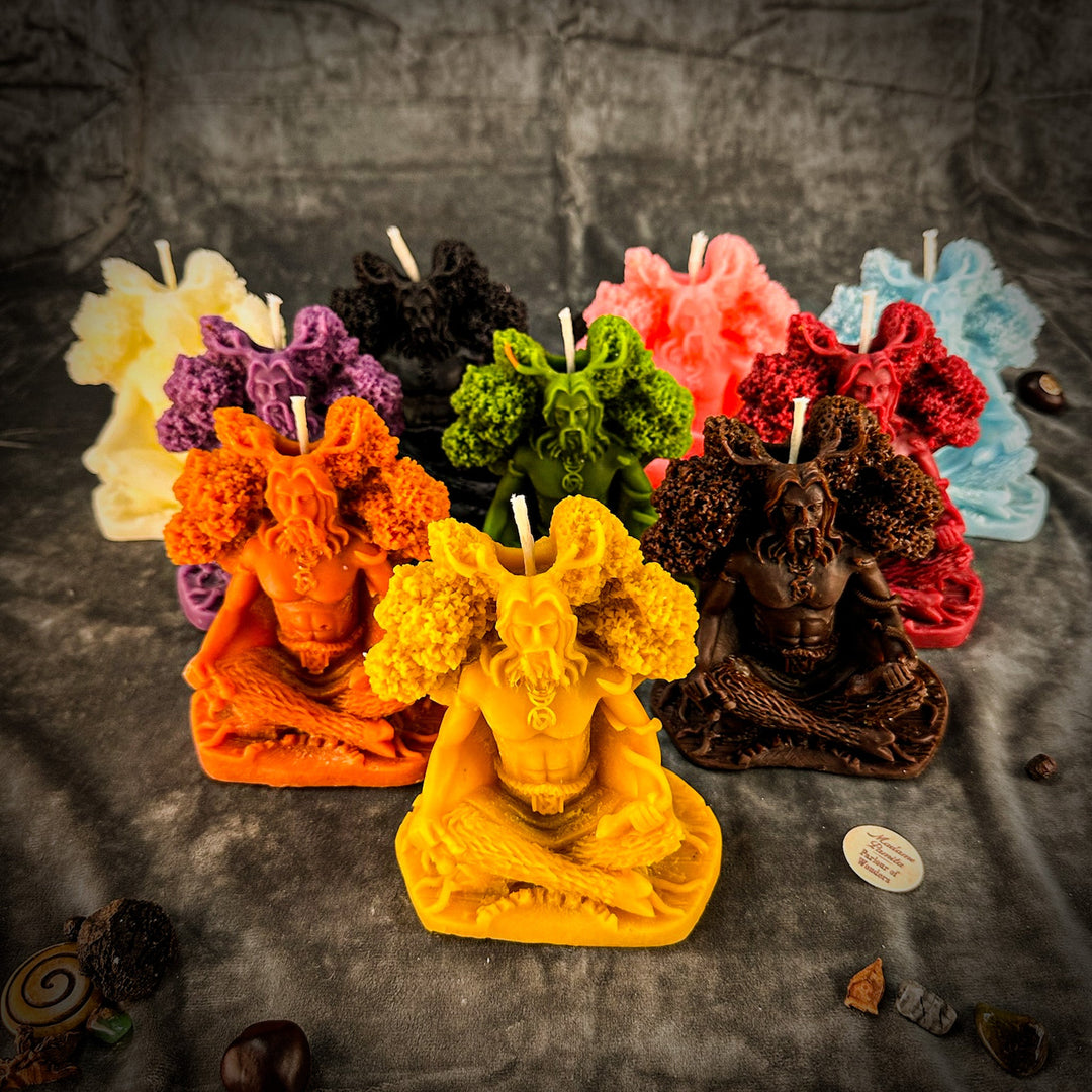 Beeswax Horned God Spell Candle with multicolored carved figure, flames, and wicks