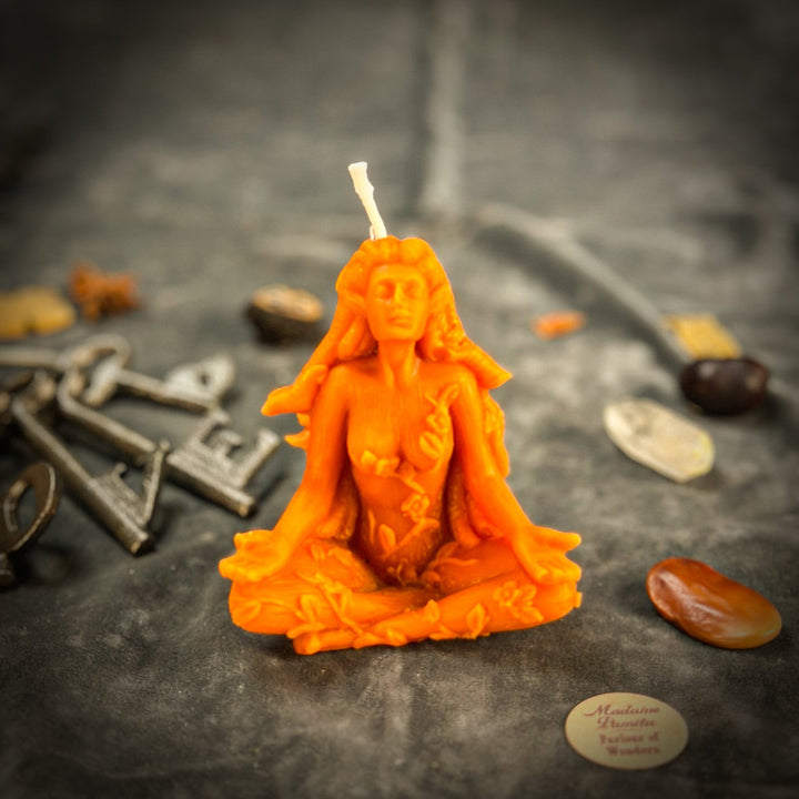 Beeswax Forest Fairy Spell Candle with glowing orange figure and raised wick, close-up angle.