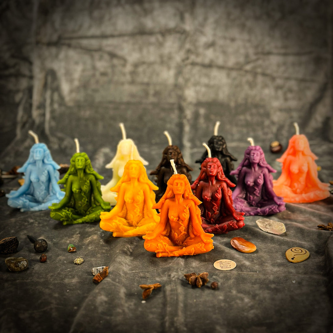 Beeswax Forest Fairy Spell Candle, multicolored seated figures on stone surface.