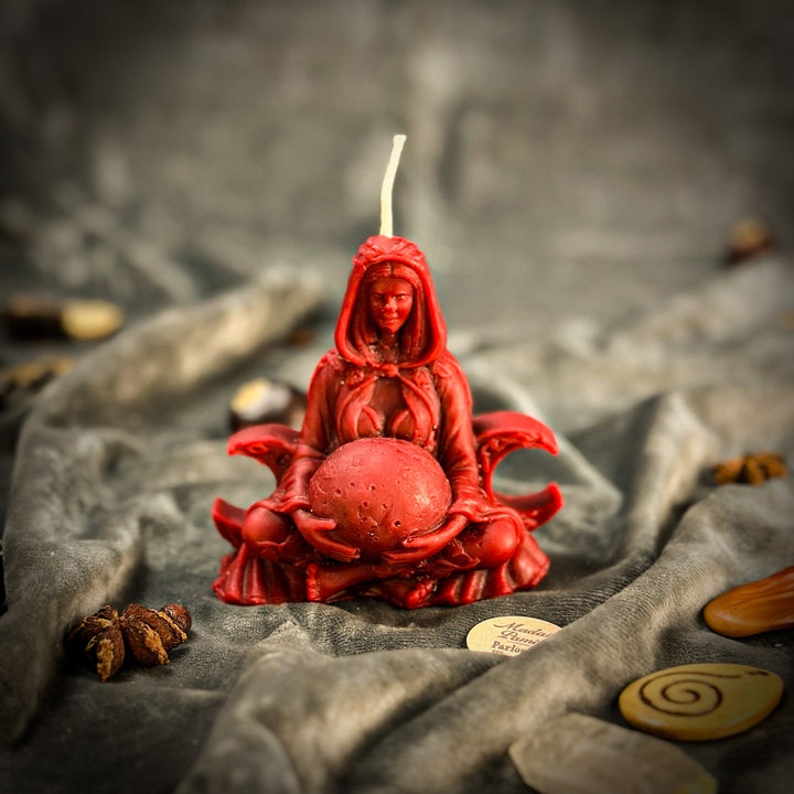 Beeswax Moon Goddess Spell Candle with red sculpted figure and glowing flame.