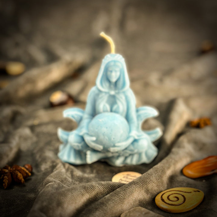 Beeswax Moon Goddess Spell Candle flame above blue star-shaped wax holder.
