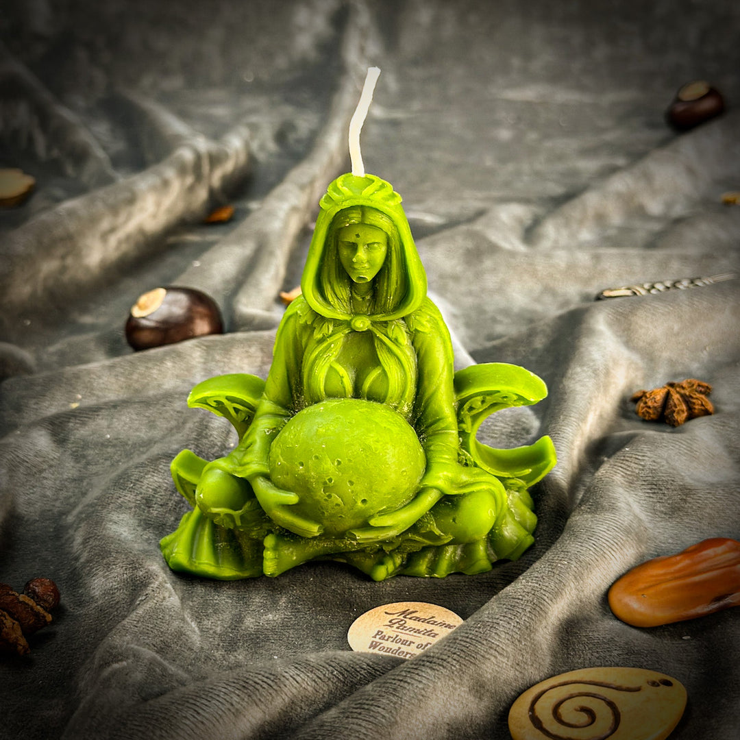 Beeswax Moon Goddess Spell Candle in bright green, lit flame, seated pose.