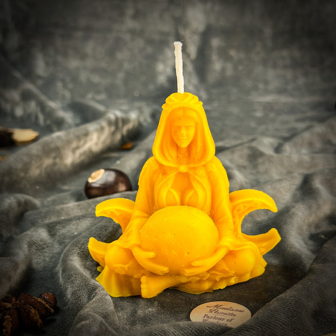 Beeswax Moon Goddess Spell Candle with glowing yellow figure, close-up flame.