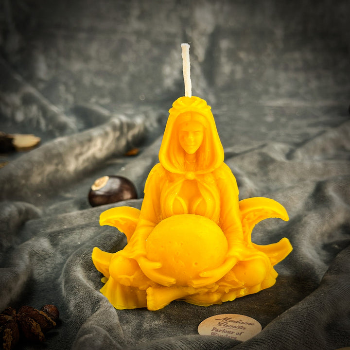 Beeswax Moon Goddess Spell Candle with glowing yellow figure, close-up flame.
