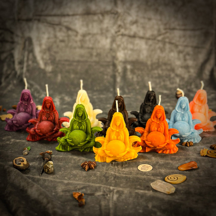 Beeswax Moon Goddess Spell Candle shaped like a seated figure, glowing yellow.
