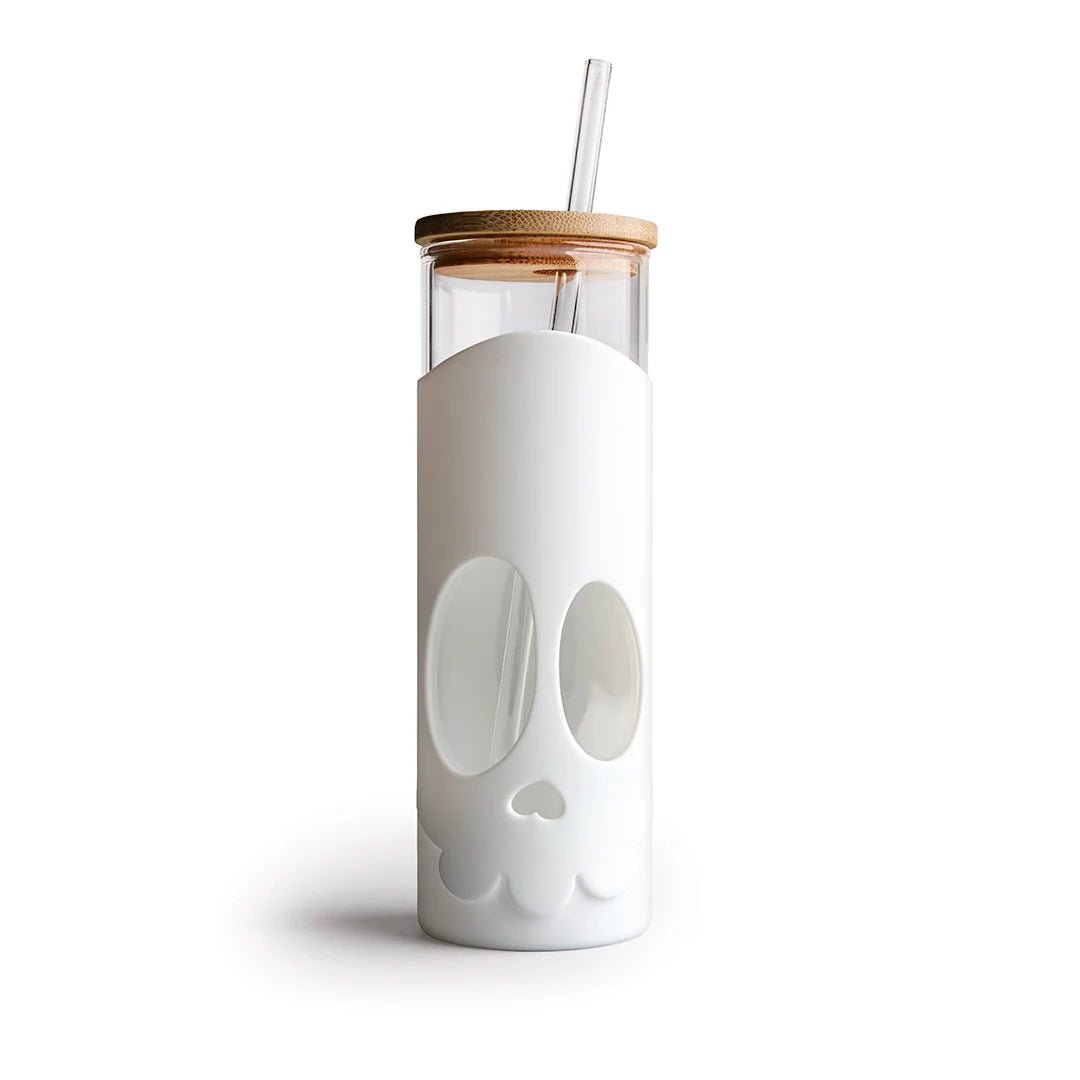 Clear tumbler with white skull design, wooden lid, and straw on a white background