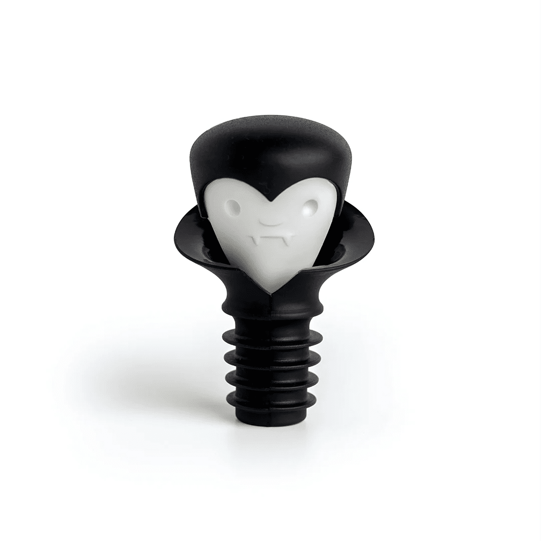 A black plastic bottle stopper shaped like a vampire head with a white heart-shaped face, shown on a clean white background.