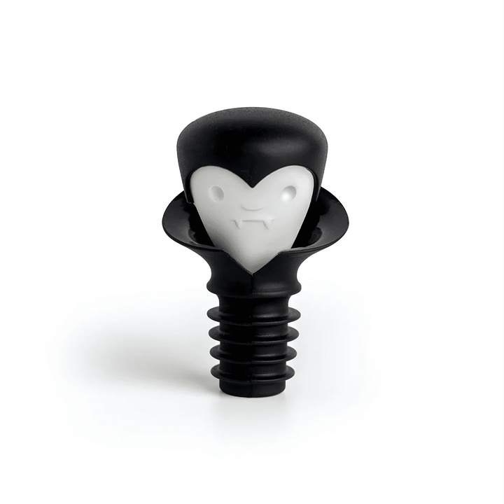 A black plastic bottle stopper shaped like a vampire head with a white heart-shaped face, shown on a clean white background.