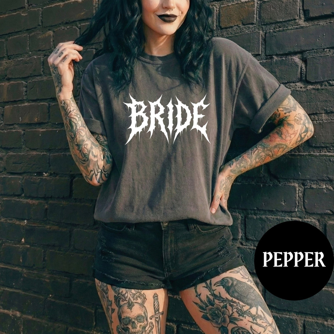 Person wearing a 'BRIDE' shirt against a brick wall with 'PEPPER' branding.