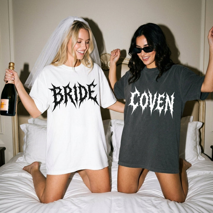 Two women on a bed, one wearing a 'BRIDE' shirt and the other wearing a 'GOVEN' shirt.