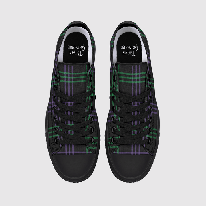 A pair of black high-top sneakers with a green and purple tartan plaid pattern on the canvas uppers, shown from a top-down view on a light gray background.