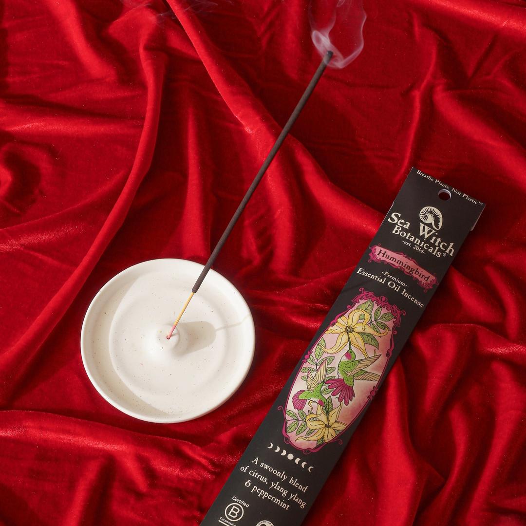 Hummingbird Premium Incense box with burning incense stick on red satin cloth