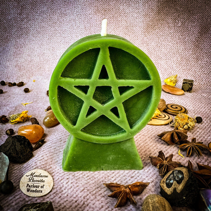 Beeswax Pentacle of Protection Spell Candle, green pentagram cutout, lit wick.