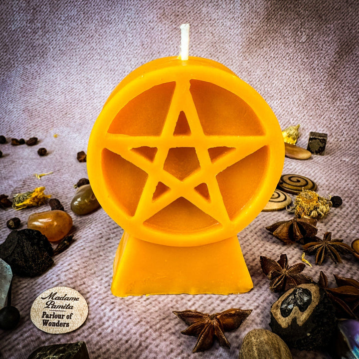 Beeswax Pentacle of Protection Spell Candle with glowing pentagram cutout, orange-yellow wax.