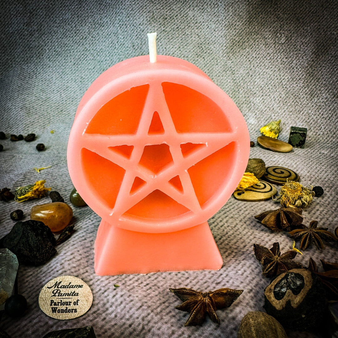 Beeswax Pentacle of Protection Spell Candle in pink, pentagram cutout, wick up.