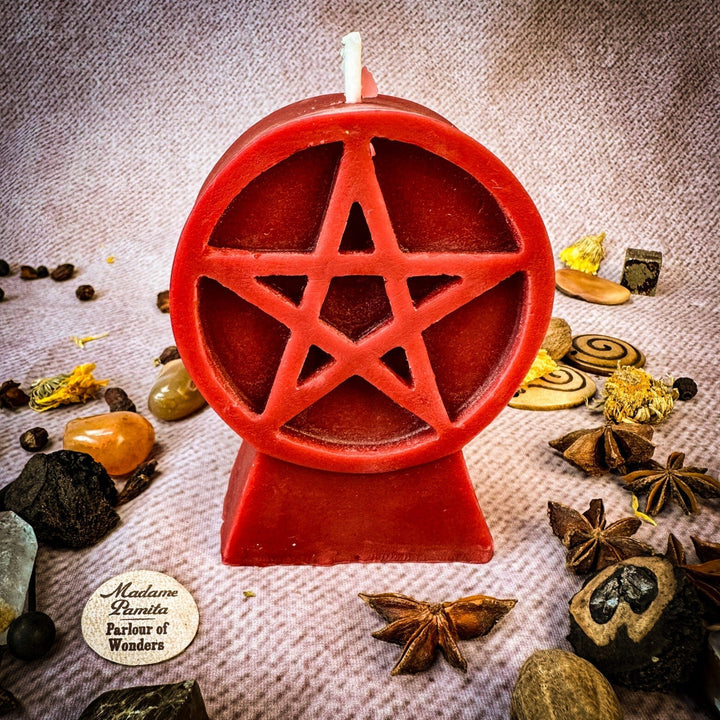 Beeswax Pentacle of Protection Spell Candle with red pentagram cutout, wick centered, on beige cloth.