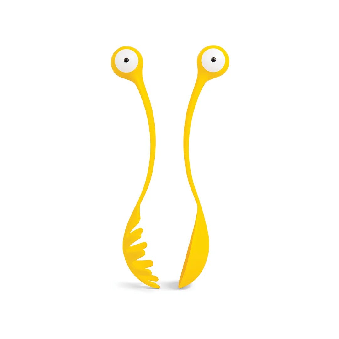 Yellow spoon and fork with googly eyes on a white background