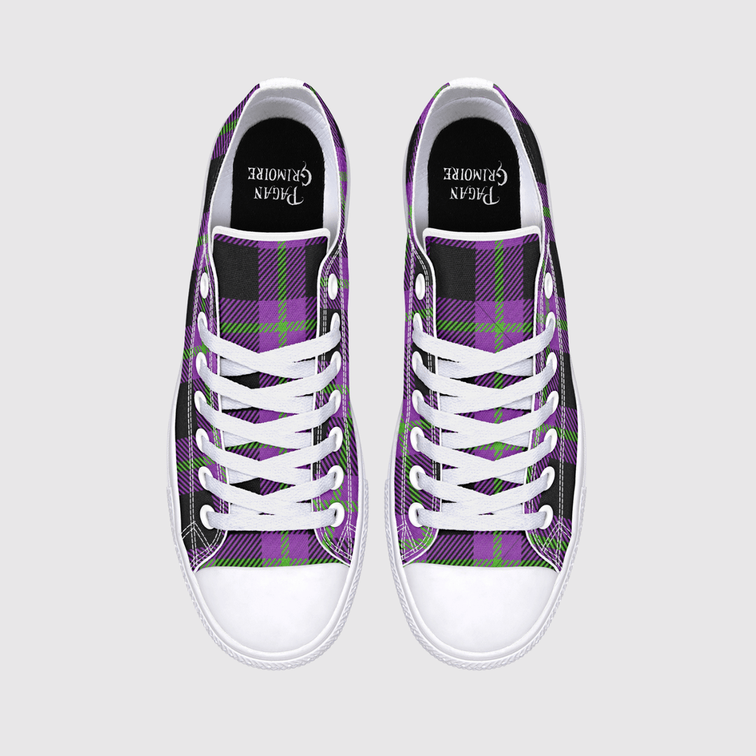 A pair of low-top sneakers shown from the back, featuring a purple, black, and green plaid pattern on the canvas uppers, a white leather heel tab, and a white rubber sole with a small logo.