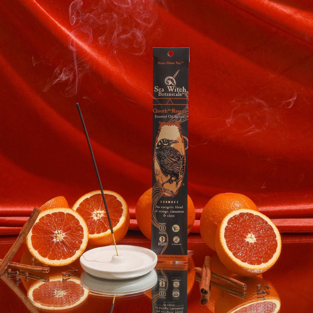 Incense gift set box beside burning incense stick on red citrus backdrop