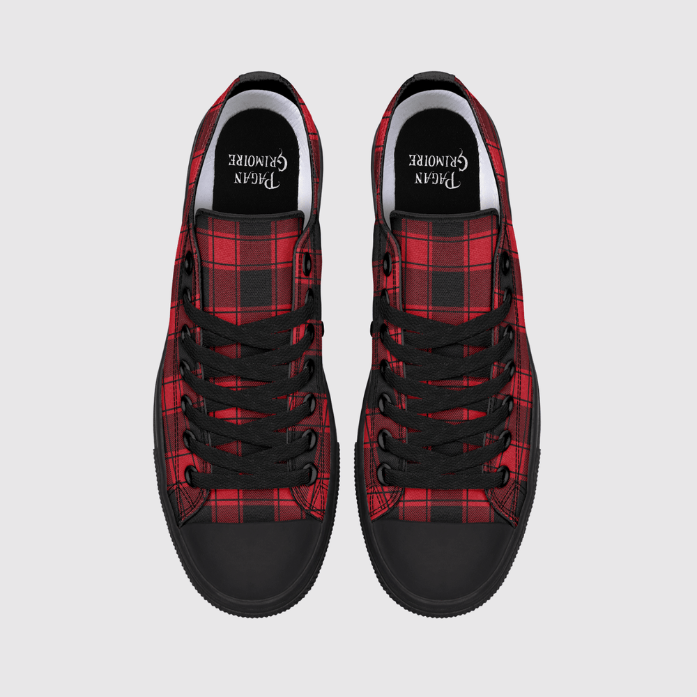 A pair of low-top canvas sneakers shown from a top-down view on a light gray background. The shoes feature a red and black tartan plaid pattern on the sides, solid black rubber toe caps and soles, black laces.