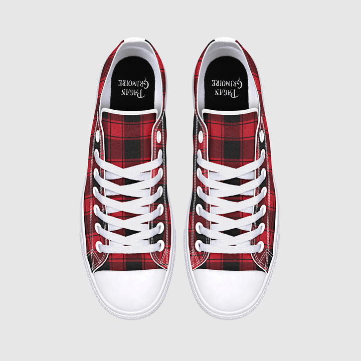 A pair of low-top canvas sneakers shown from a top-down view on a light gray background. The shoes feature a red and black tartan plaid pattern on the sides, white laces, white rubber toe caps, and a black insole.