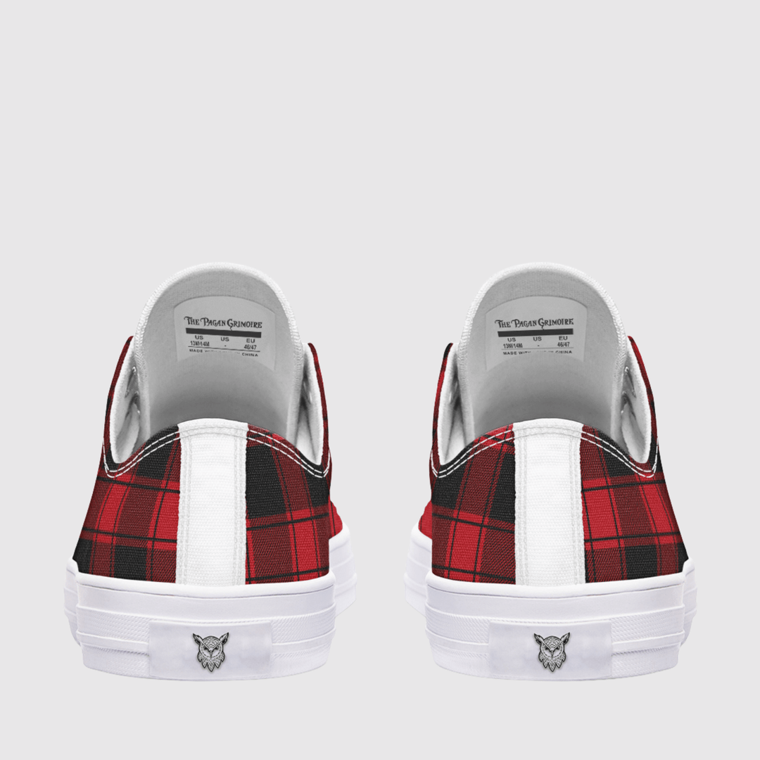 A pair of low-top sneakers shown from the back, featuring a red and black plaid pattern on the sides, a white vertical stripe, and a white rubber sole with a small logo.