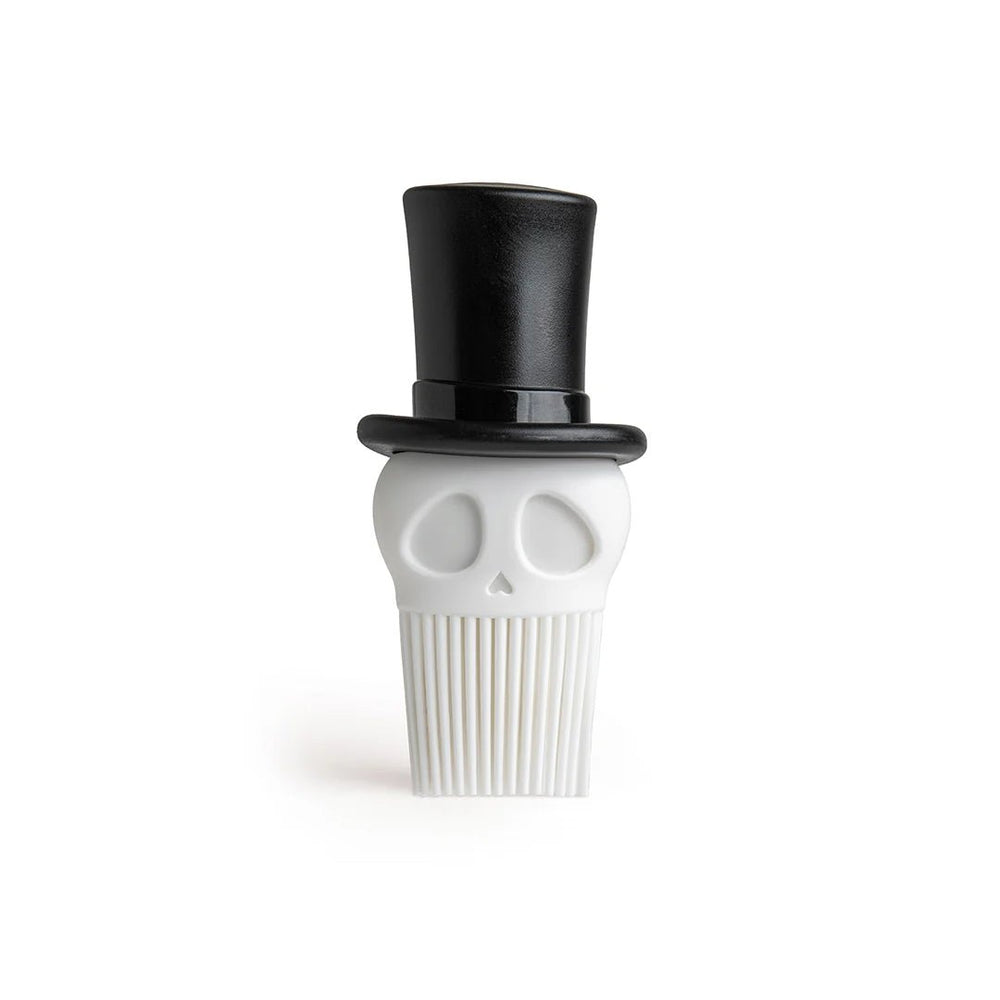 Skull-shaped white brush with black top hat on a white background