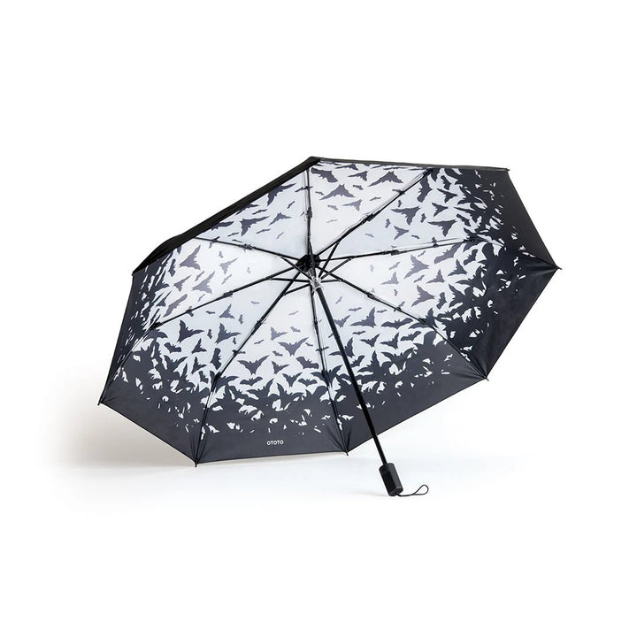 Black umbrella with butterfly pattern on a white background