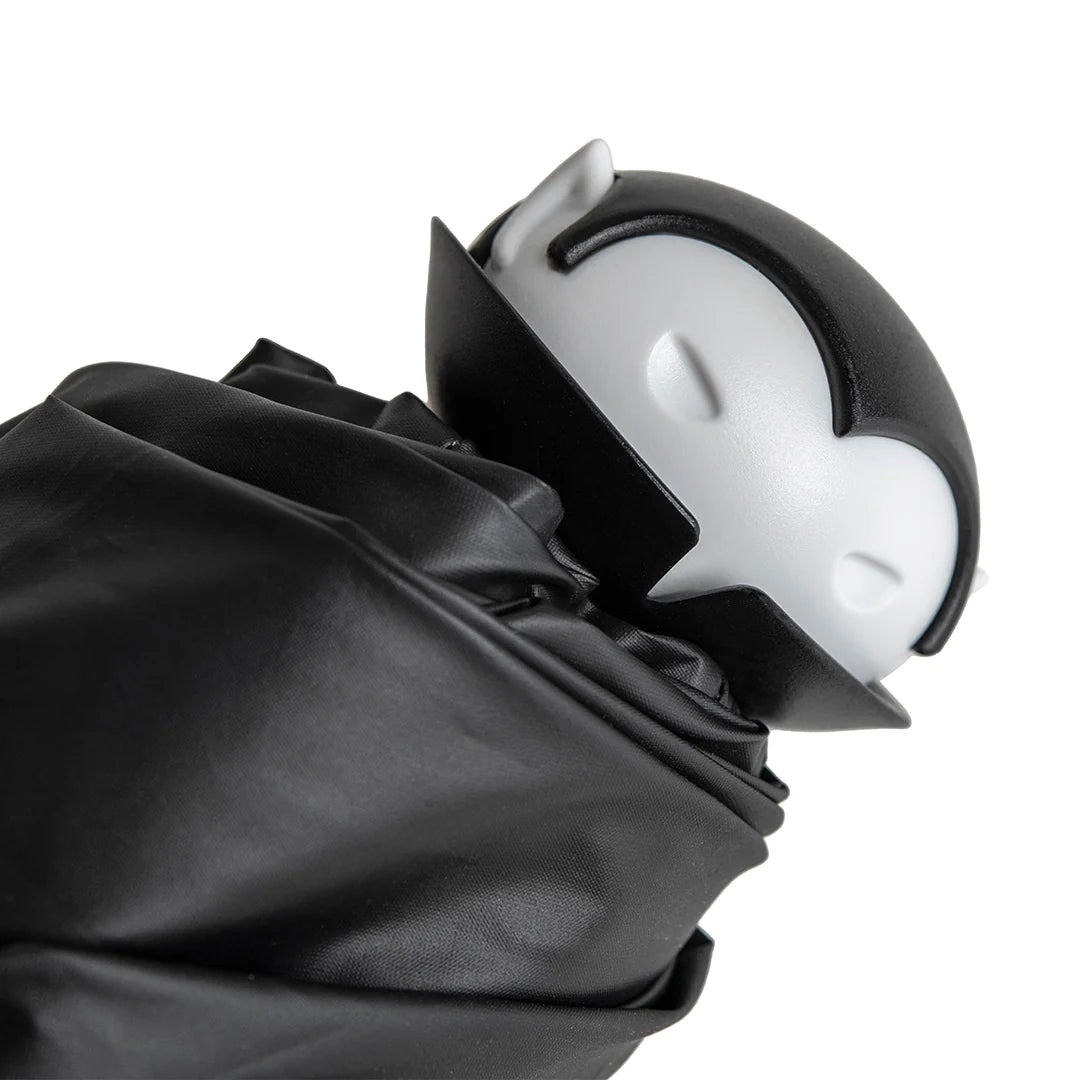 Black umbrella with a white and gray handle on a white background