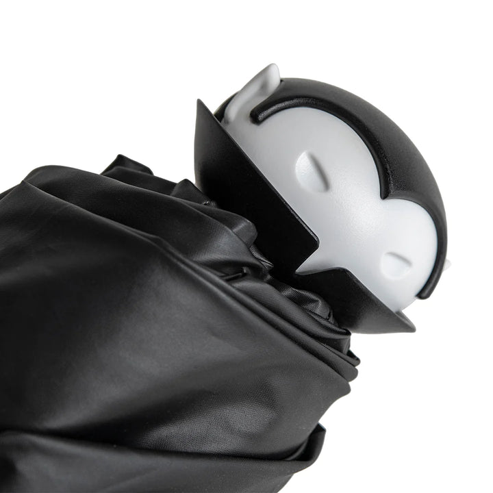 Black umbrella with a white and gray handle on a white background
