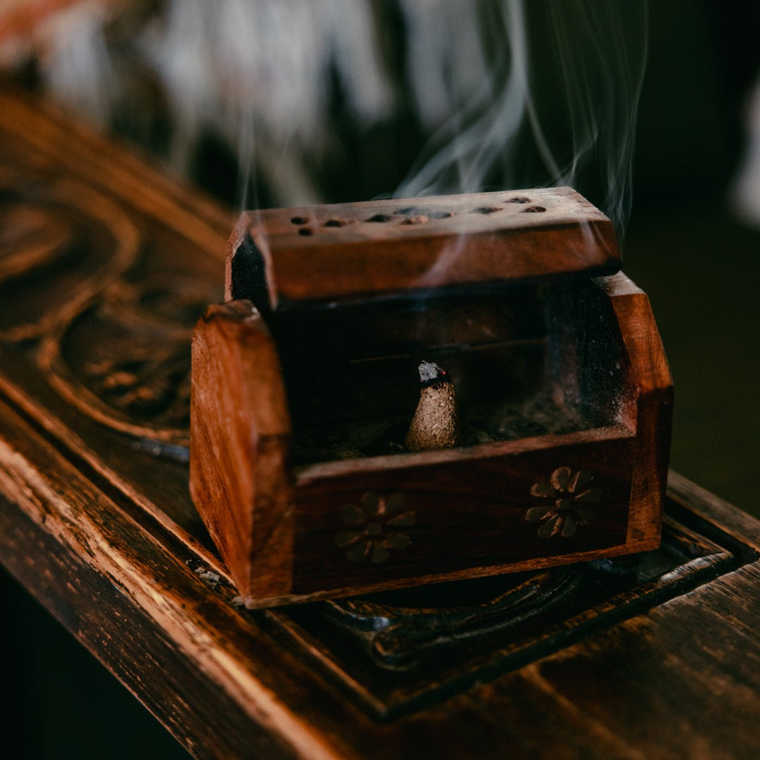 the wish granter wooden box with dark metal latch, smoky incense smoke.