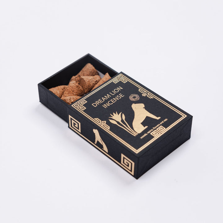 the wish granter black box with gold border, open top revealing incense pieces
