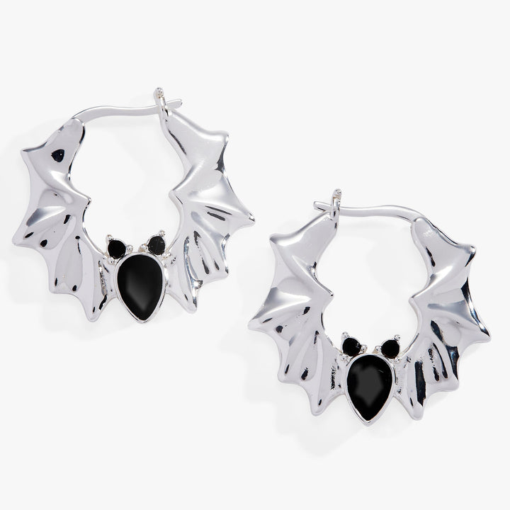 Silver bat-shaped earrings with black accents on a white background