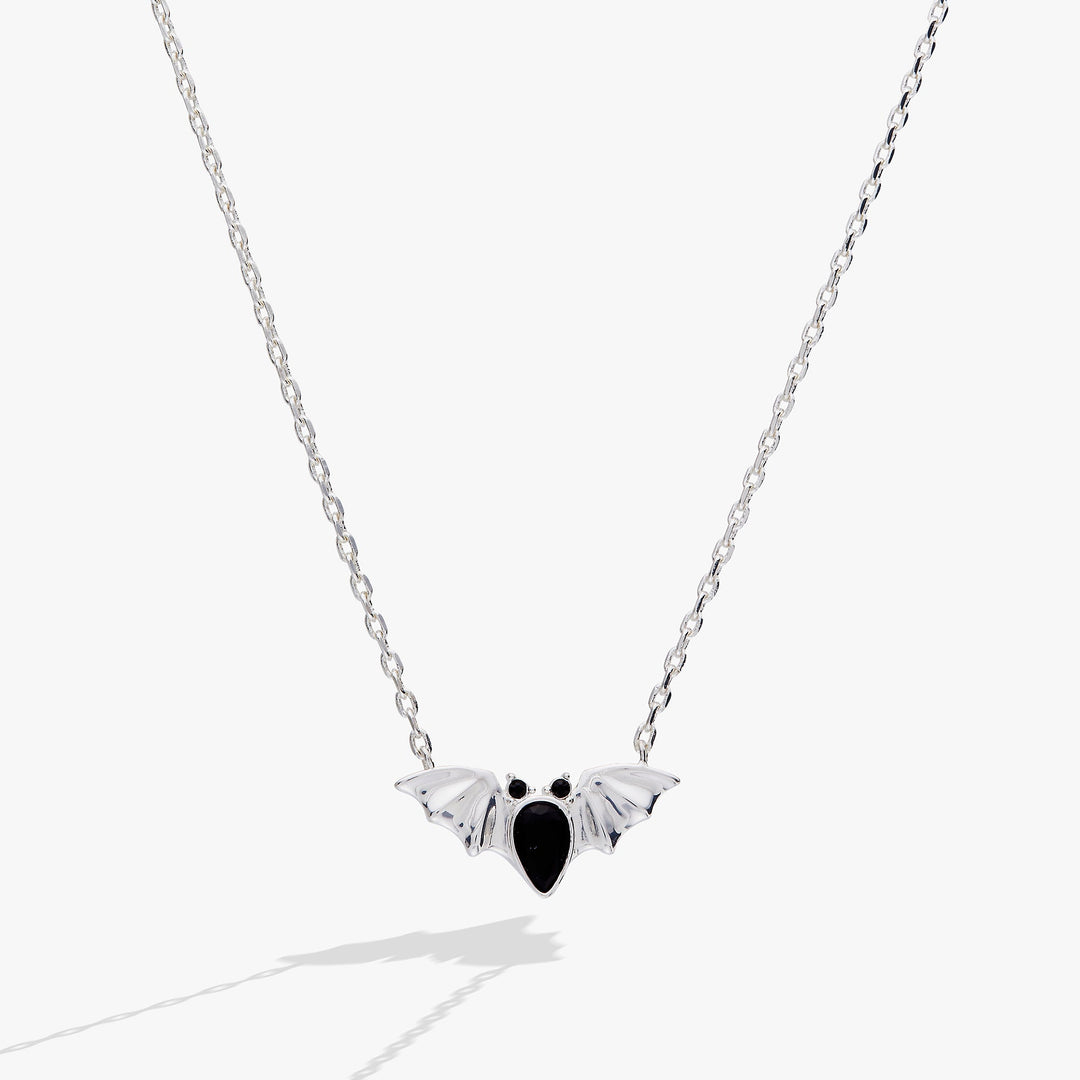 Silver necklace with a bat-shaped pendant on a white background