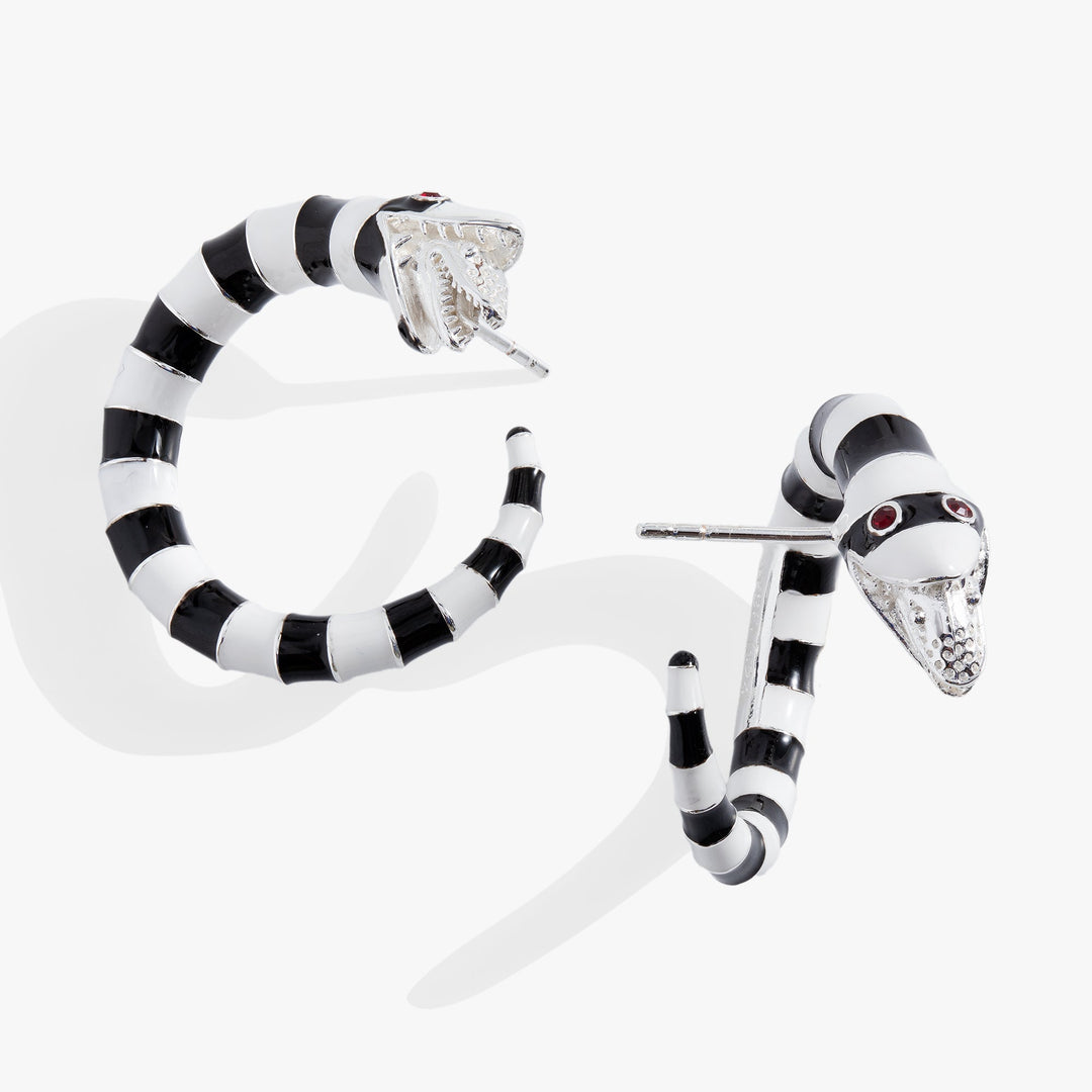 Black and white striped snake-shaped earrings on a white background
