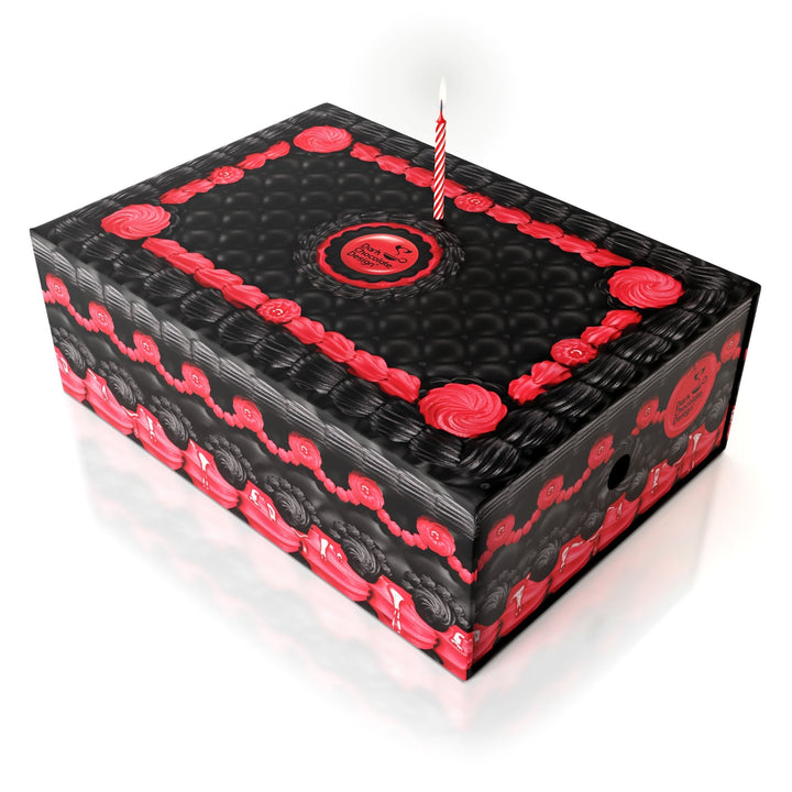 Decorative shoe box top with red roses and black striped pattern, candle.