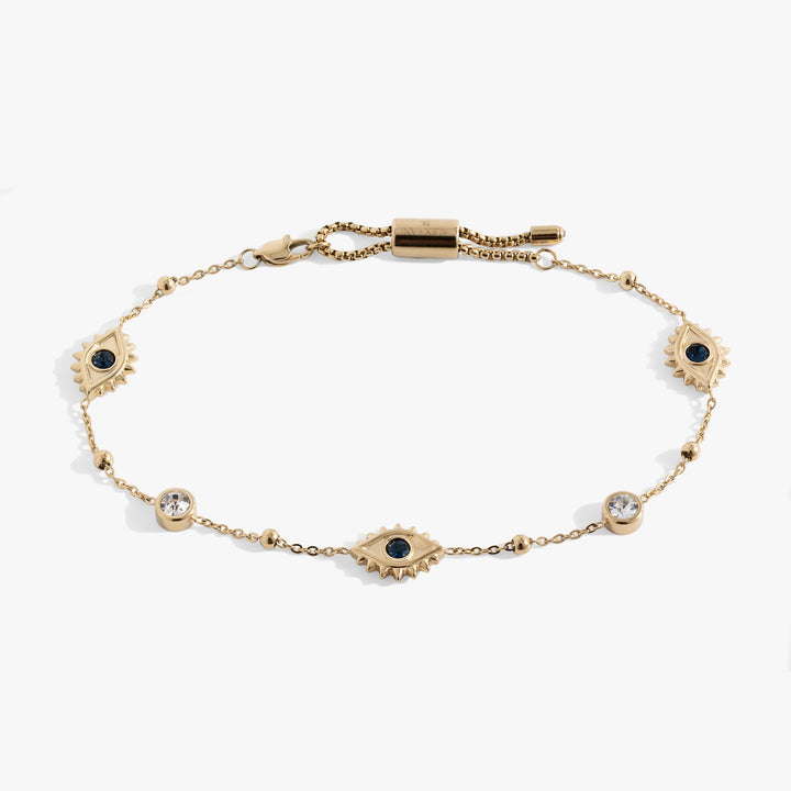 A gold chain bracelet featuring three sunburst evil eye motifs with black centers, one larger central eye, and three smaller sunburst eyes spaced along the chain, with a lobster clasp closure at the top.